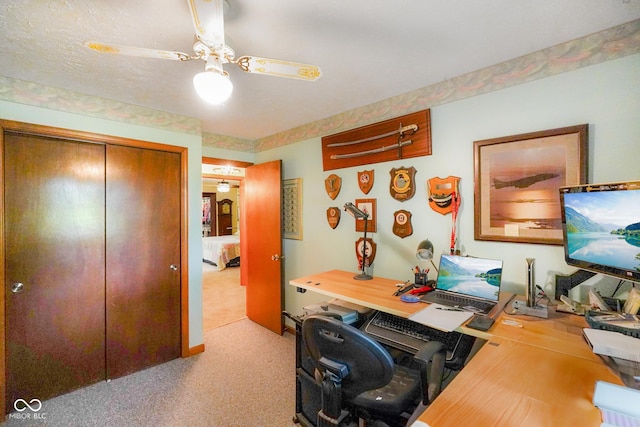 office with light carpet and a ceiling fan