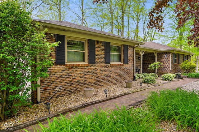 single story home featuring brick siding