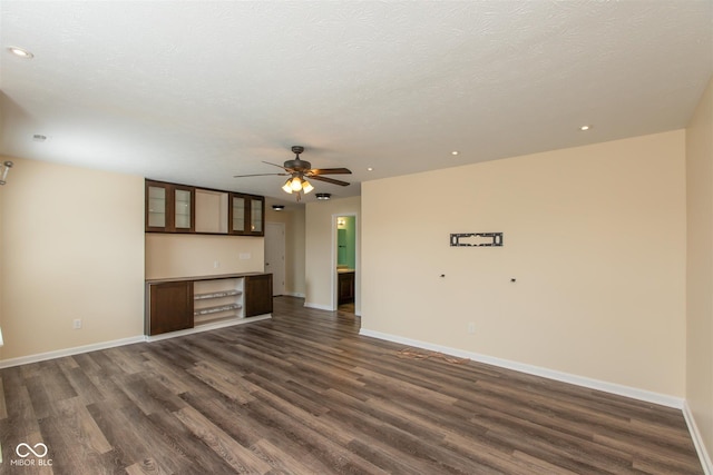unfurnished living room featuring dark wood-style flooring, recessed lighting, ceiling fan, and baseboards