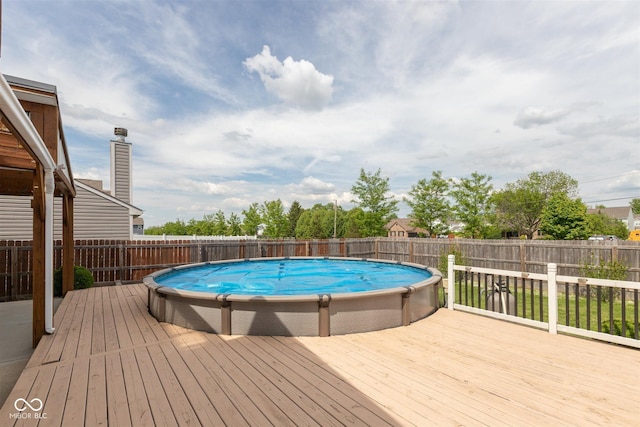 view of swimming pool with a deck and a fenced backyard