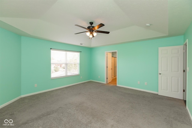 unfurnished bedroom featuring carpet flooring, baseboards, vaulted ceiling, and a ceiling fan