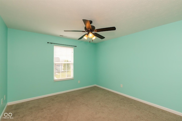 empty room featuring ceiling fan, carpet flooring, and baseboards