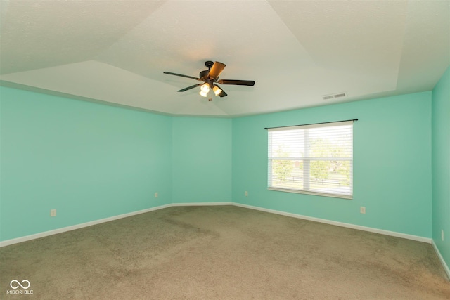 spare room featuring carpet, ceiling fan, baseboards, and lofted ceiling
