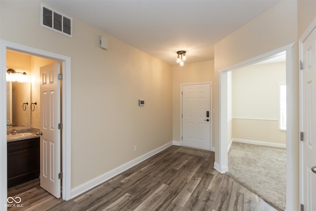 foyer with wood finished floors and baseboards