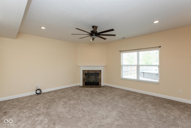 unfurnished living room with a ceiling fan, carpet flooring, a fireplace, recessed lighting, and baseboards