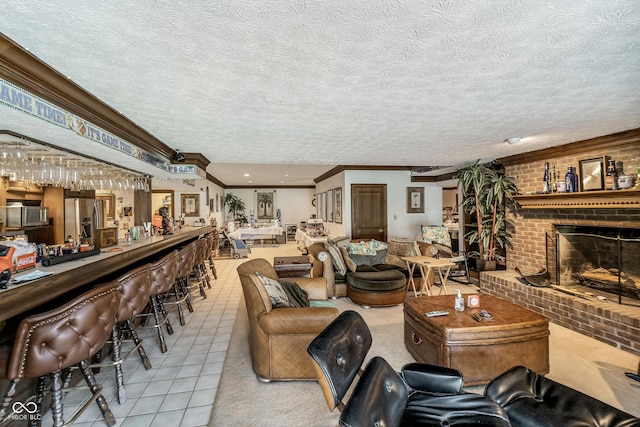 tiled living area with crown molding, a fireplace, and a textured ceiling