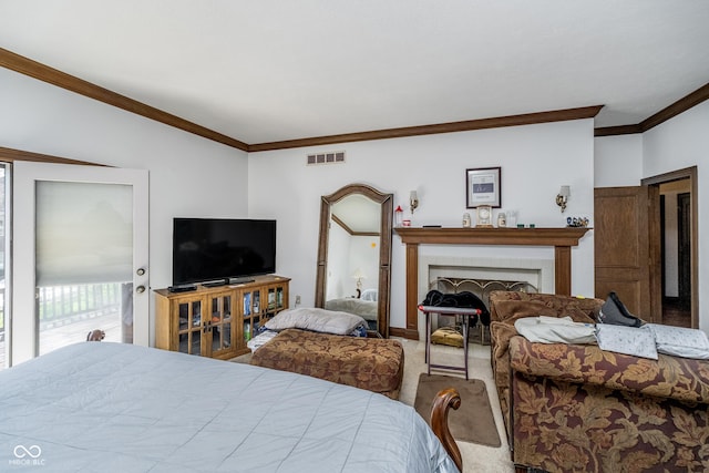 carpeted bedroom featuring crown molding, visible vents, and a fireplace