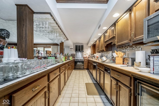 kitchen with stainless steel appliances, recessed lighting, light tile patterned floors, and wine cooler