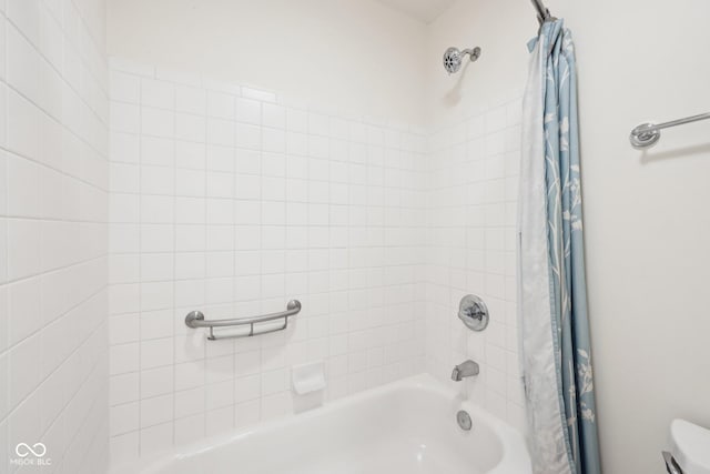 bathroom with shower / bath combination with curtain and toilet