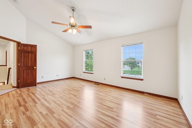 unfurnished room featuring light wood-type flooring, lofted ceiling, baseboards, and a ceiling fan