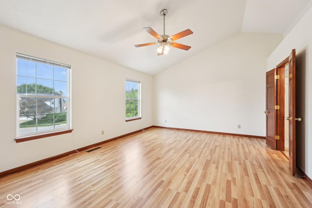 unfurnished room with lofted ceiling, light wood-type flooring, baseboards, and a ceiling fan