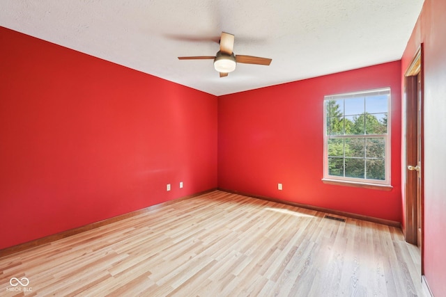 empty room featuring wood finished floors and a ceiling fan