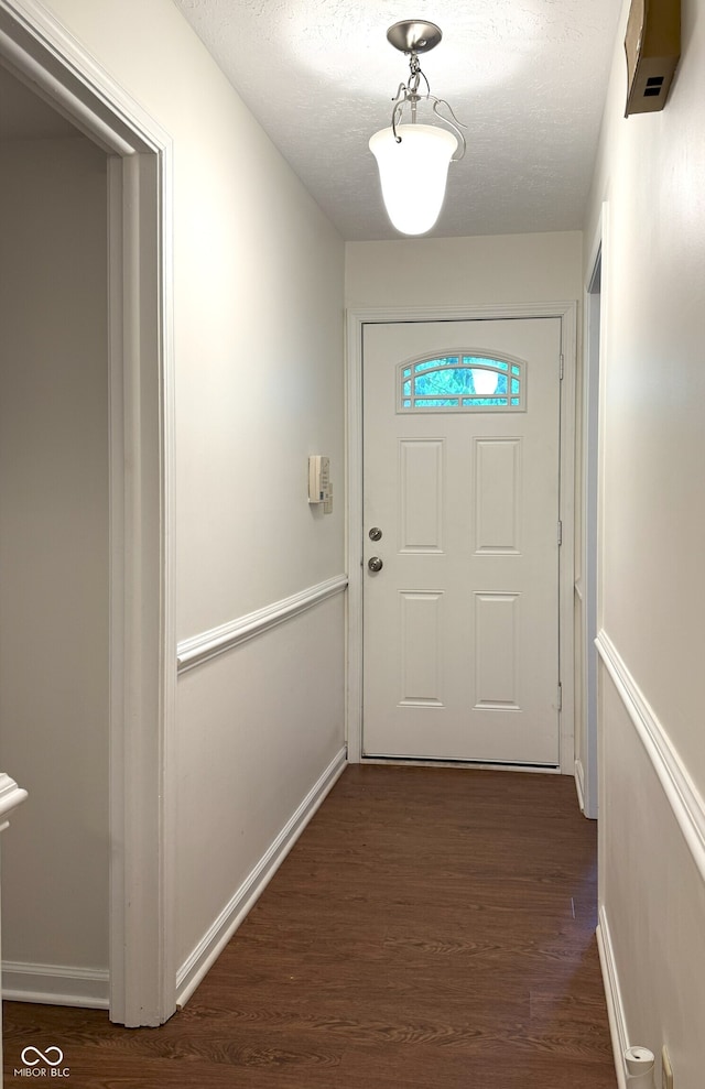 4212 Foxglove Trce, Indianapolis, IN 46237 - doorway to outside with dark wood finished floors, baseboards, and a textured ceiling
