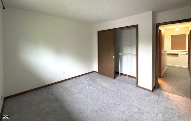 4212 Foxglove Trce, Indianapolis, IN 46237 - unfurnished bedroom featuring carpet floors, a closet, baseboards, and a textured ceiling