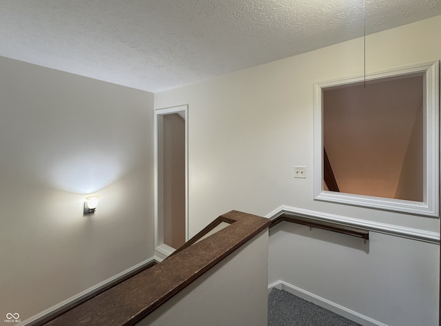 4212 Foxglove Trce, Indianapolis, IN 46237 - hallway featuring an upstairs landing and a textured ceiling