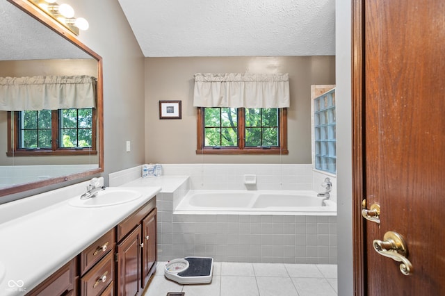 full bathroom featuring vanity, a garden tub, tile patterned floors, and a healthy amount of sunlight