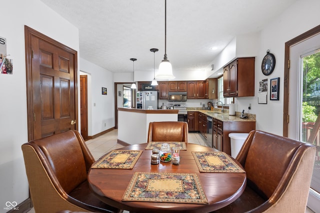 dining space featuring light tile patterned floors and baseboards