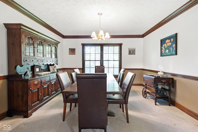 dining space featuring a textured ceiling, light colored carpet, crown molding, baseboards, and a chandelier
