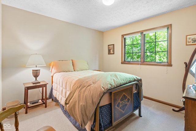 bedroom with carpet floors, a textured ceiling, and baseboards