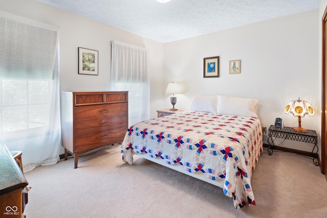 carpeted bedroom with a textured ceiling