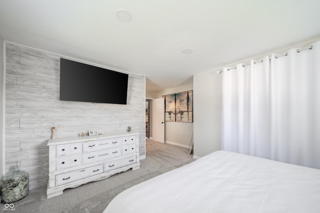bedroom with baseboards and light carpet