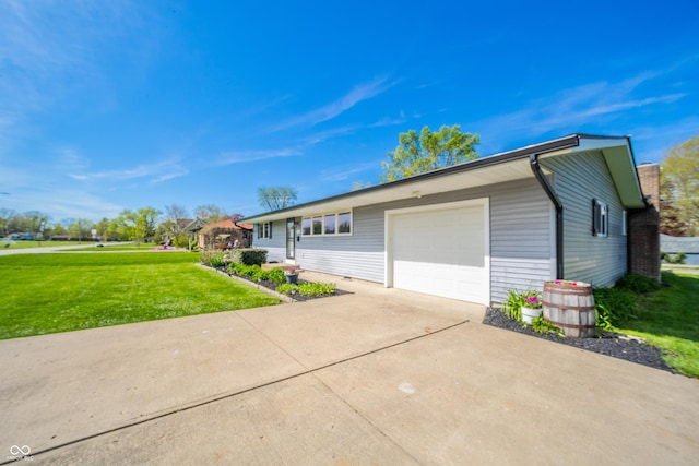 ranch-style house with concrete driveway, an attached garage, and a front lawn