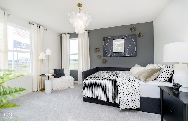 carpeted bedroom featuring multiple windows and a chandelier