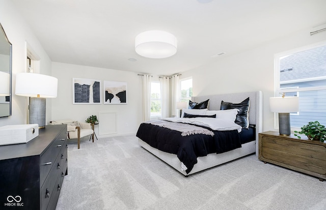 bedroom with light colored carpet, baseboards, and visible vents