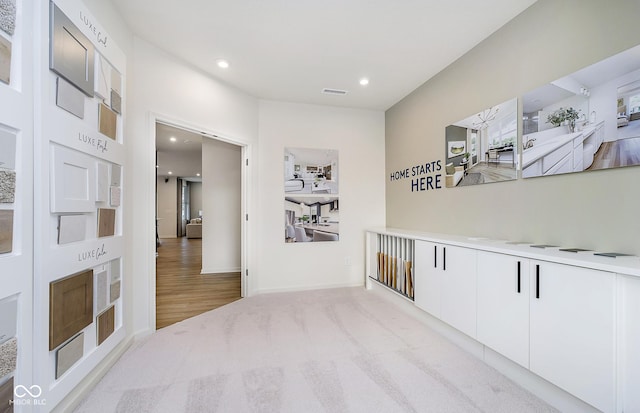 corridor featuring baseboards, recessed lighting, visible vents, and carpet floors