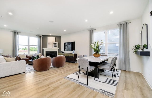 dining room with a wealth of natural light, light wood-style floors, and recessed lighting