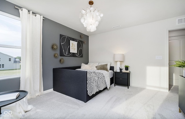 bedroom with baseboards, carpet flooring, an inviting chandelier, and visible vents