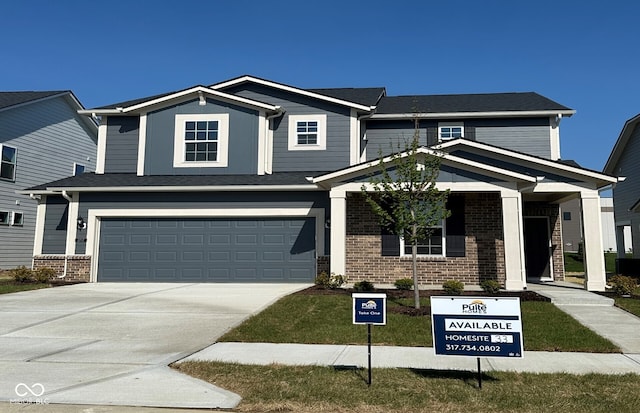 view of front of house with a garage, brick siding, and driveway