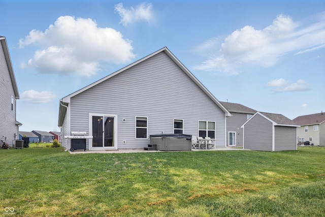 1666 Huntzinger Blvd, Pendleton, IN 46064 - rear view of property featuring a hot tub, a patio, central air condition unit, and a lawn