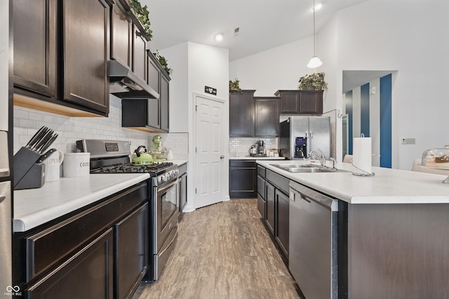 1666 Huntzinger Blvd, Pendleton, IN 46064 - kitchen featuring stainless steel appliances, wall chimney exhaust hood, light countertops, dark brown cabinets, and light wood-style floors