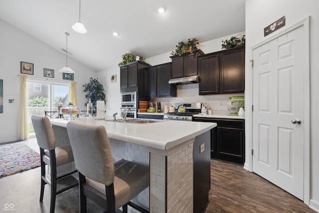 1666 Huntzinger Blvd, Pendleton, IN 46064 - kitchen featuring a sink, a breakfast bar area, under cabinet range hood, backsplash, and appliances with stainless steel finishes