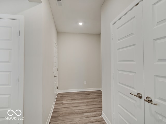 hall featuring visible vents, recessed lighting, light wood-style flooring, and baseboards
