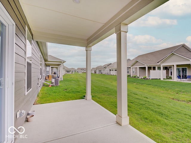view of patio featuring central air condition unit and a residential view