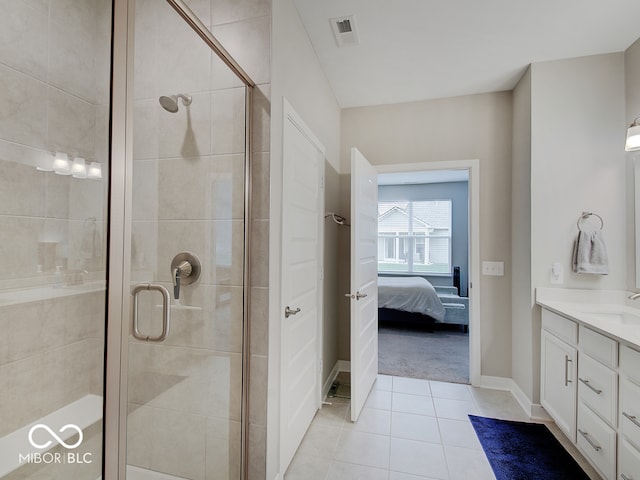 ensuite bathroom featuring visible vents, vanity, tile patterned floors, and a shower stall