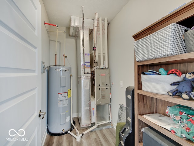 utility room featuring heating unit and water heater