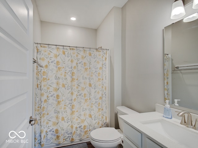 bathroom featuring vanity, a shower with curtain, and toilet