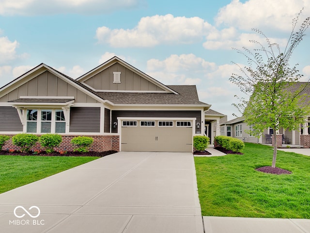 craftsman-style home featuring board and batten siding, driveway, a front yard, brick siding, and an attached garage