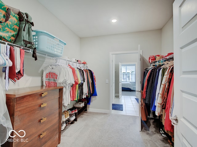 spacious closet with carpet flooring and tile patterned flooring