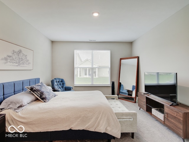 bedroom with visible vents and carpet