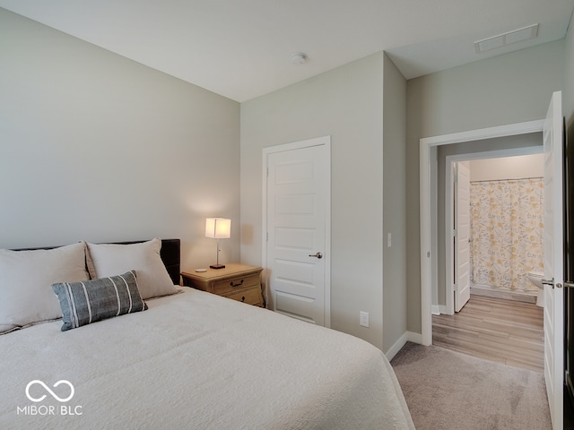 bedroom featuring light colored carpet, baseboards, and visible vents