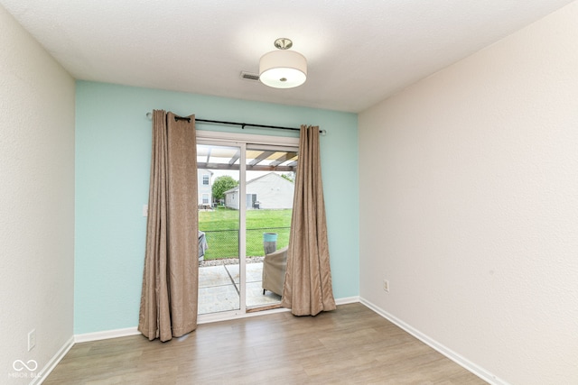 unfurnished room featuring light wood finished floors and baseboards