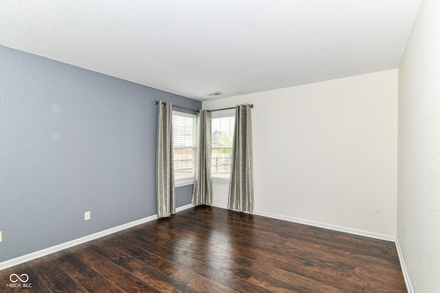 unfurnished room featuring wood finished floors and baseboards