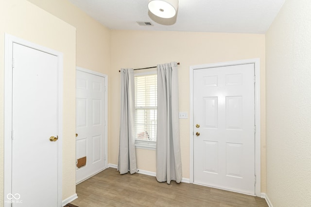 entrance foyer featuring light wood-style floors and baseboards