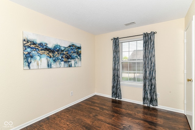 unfurnished room featuring wood finished floors and baseboards