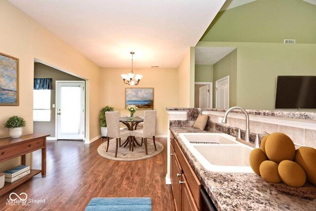 2342 Sheek Rd, Greenwood, IN 46143 - kitchen with a sink, dark wood-style flooring, a chandelier, hanging light fixtures, and brown cabinetry