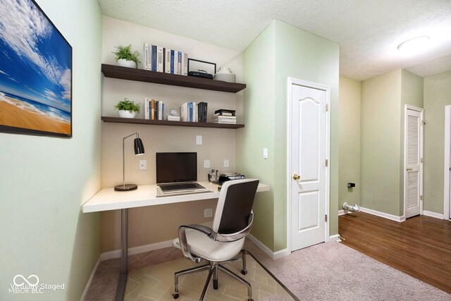2342 Sheek Rd, Greenwood, IN 46143 - office with built in desk, baseboards, carpet, and a textured ceiling
